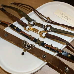 Vintage leather choker set featuring butterfly and heart pendants in neutral tones