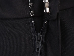 Detail of the high-quality metal zipper and dual hook closure on black trousers