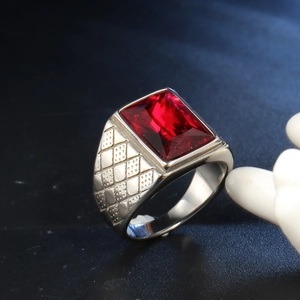 Close-up of square red gemstone ring with lattice pattern on silver stainless steel band