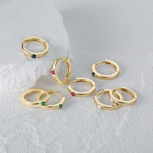 Detailed macro view of S925 silver gold-plated hoop earrings with colorful zircon stones