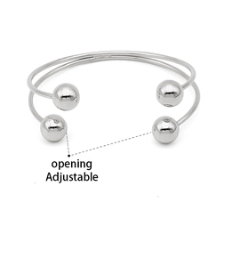 Detail of adjustable silver stainless steel double layer bangle with four ball ends