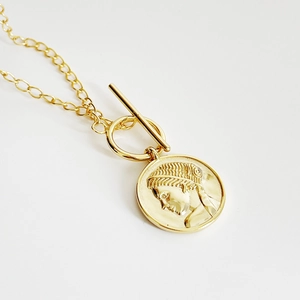Gold double-layer necklace with vintage coin pendant and toggle clasp closure