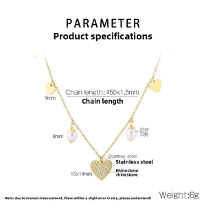 Detailed view of gold stainless steel necklace with crystal heart and white pearl charms
