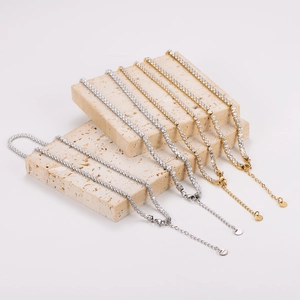 Elegant gold and silver tennis bracelets with cubic zirconia on beige stone pedestals