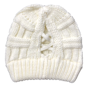 Close-up of white cable knit beanie with hollow cross pattern and ribbed cuff detailing