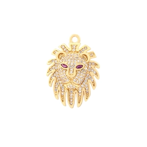 Detailed macro view of a golden lion head charm with pavé cubic zirconia and ruby eyes