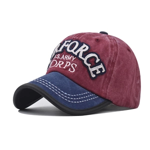 Detail of vintage cotton baseball cap with embroidered military text and washed texture