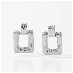 Detail of silver square hoop earrings featuring a unique hammered texture finish