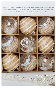 Close-up of 9-piece Christmas ball set with reindeer, snowflake patterns and lace in a kraft box