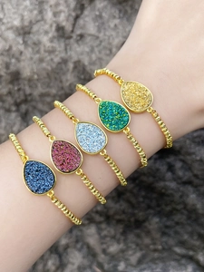 Detail showing a set of 5 bohemian copper plated bracelets with teardrop crystals on wrist