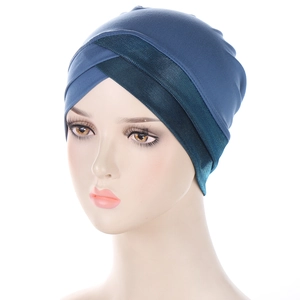 Detail view of blue elastic turban featuring cross-front design and breathable mesh fabric
