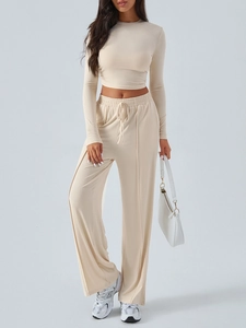 Close-up of beige yoga lounge set with cropped long sleeve top and drawstring pants