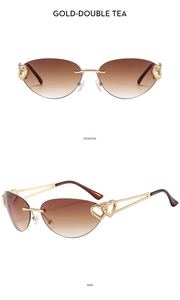 Detail of rimless Y2K sunglasses featuring gold heart-shaped cutouts and tea gradient lenses