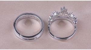 Detail of silver crown ring and plain band featuring adjustable open design and small diamonds