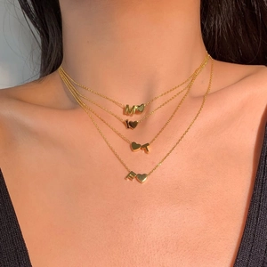 Layered S925 sterling silver gold necklace with heart and letter pendants on a model