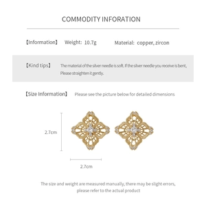 Detail view of hollow geometric flower earrings in gold finish with zircon inlay