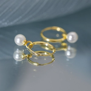 Macro shot showing S925 hallmark on the gold-plated sterling silver pearl hoop earrings