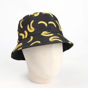 Close-up of black canvas bucket hat featuring vibrant all-over yellow banana prints
