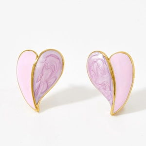 Macro shot of asymmetric heart stud earrings with pink and purple marbled enamel and gold base
