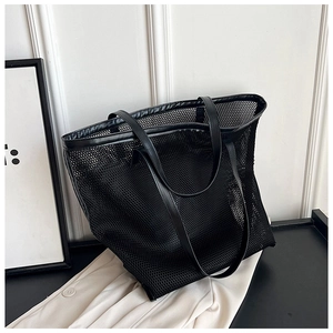 Close-up of black mesh tote bag showing breathable texture and durable leather handle