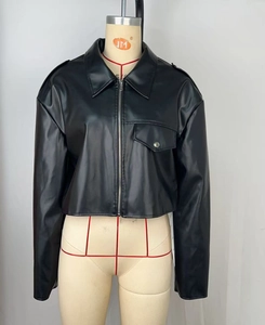 Detailed view of women's short black faux leather jacket with zipper and lapel design