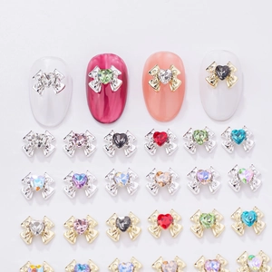 Detailed view of colorful 3D bowknot heart charms for DIY nail art decoration