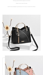Detail of trendy crossbody bag with circular metal handle and heart pearl tassel decoration