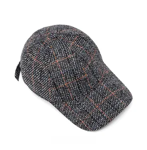 Detailed top view of a tweed plaid baseball cap showing vintage orange and blue patterns