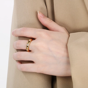 Detail of 18K gold plated minimalist ring with inlaid diamonds on model finger