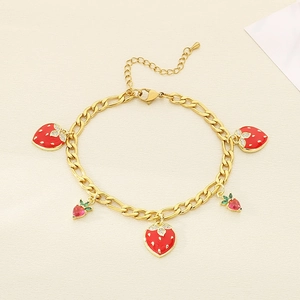 Detail of gold strawberry pendant bracelet with red enamel charms and Figaro chain links