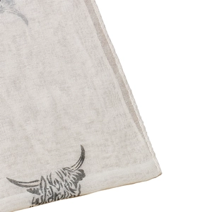 Macro detail of breathable woven fabric scarf featuring artistic highland cow head print