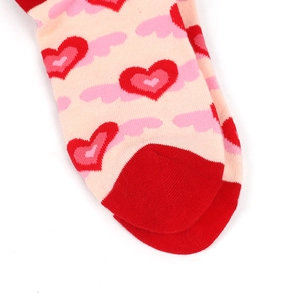 Close-up of pink and red knit cotton socks with heart patterns on the toe area