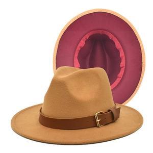 Close-up of wool fedora with brown leather band, gold buckle, and burgundy lining