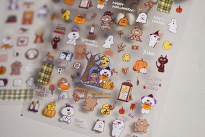 Detail of Halloween nail art stickers with cartoon pumpkin, ghost, and cat patterns
