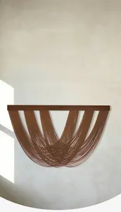 Macro detail of dark brown woven cotton macrame layers on solid wood hanging beam