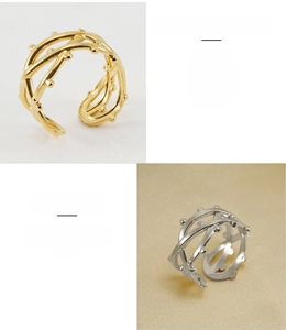 Detail of twisted woven design ring in gold and silver finish made of stainless steel