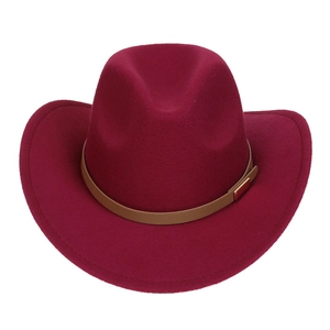 Detail of burgundy wool fedora hat featuring a brown leather band and gold metal buckle