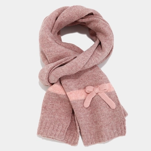 Detail of pink knitted scarf with textured mixed yarn and decorative bow accent