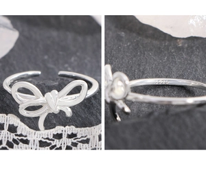 Macro shot showing S925 silver hallmark and bow detail on an irregular wrap ring