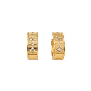 Vintage gold hoop earrings with vertical texture and zircon flowers on white background