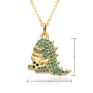 Detail of gold-plated dinosaur pendant with green and black crystals, 16mm x 17mm size