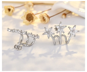 Macro view of flower stud earrings with sparkling zircons and butterfly backs