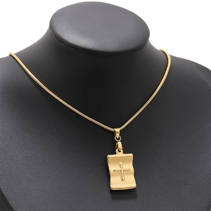 18k gold stainless steel scroll cross pendant necklace displayed on a black mannequin stand