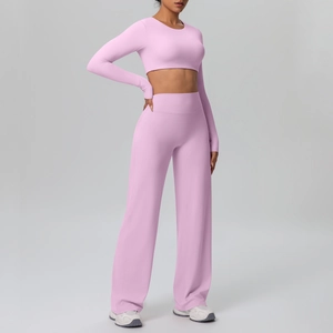 Detail of pink long sleeve crop top and high waist wide leg yoga pants set for women