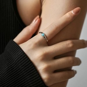 Elegant S925 sterling silver ring featuring a blue opal gemstone on a hand