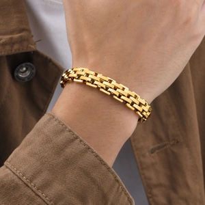 Close-up of men's gold stainless steel watch band bracelet worn on a wrist