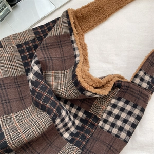 Detail view of vintage plaid tote bag with brown faux shearling trim and warm texture