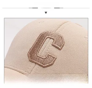 Macro detail of beige baseball cap featuring premium 3D embroidered brown C letter
