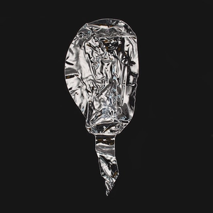 Deflated transparent round BOBO balloon in a stretched silver foil state on black background