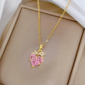 Elegant gold titanium necklace featuring a pink heart stone pendant with white zircon accents